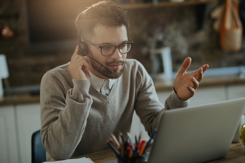 young entrepreneur having conference call over a computer while young entrepreneur having conference call over a computer while